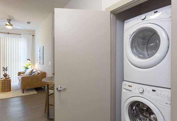 Laundry room with high-efficiency washers and dryers at Azul Lakeshore Apartments