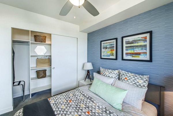 Modern lounge with large TV, sectional sofa, and bean bag at Radius Apartments, offering a relaxing communal space for residents to unwind and socialize