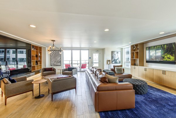 Radius Apartments: Spacious kitchen with island, bar stools, and large windows for luxurious living