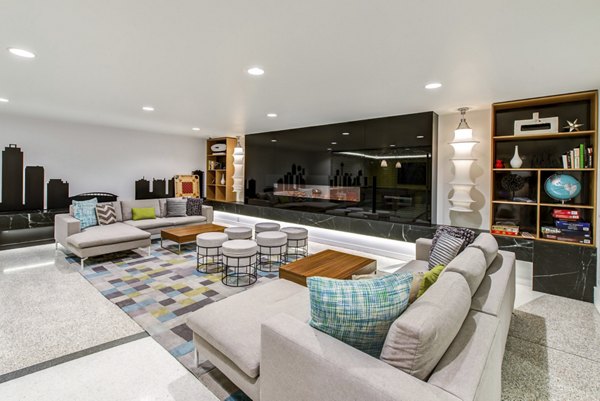 Radius Apartments: Spacious living room with leather sofas, TV, and large windows