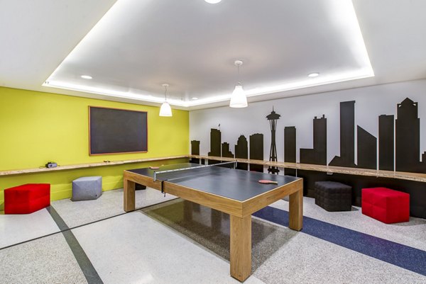 Modern lounge with sofas, stools, and wall decor at Radius Apartments