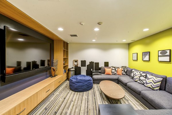 Game room with bean bag seating, wall art, and shelving at Radius Apartments luxury community