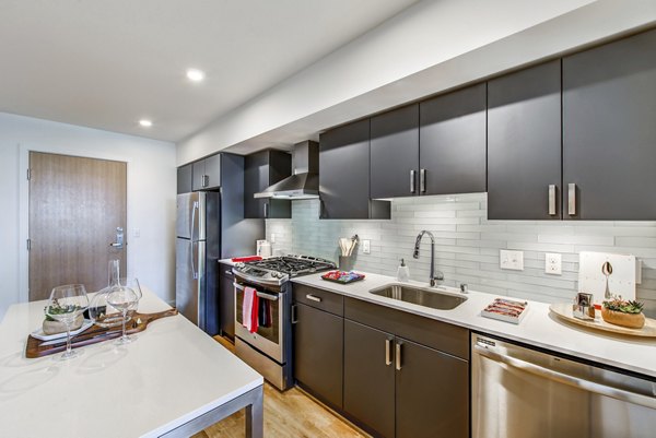 Bright living room with colorful decor leading to adjacent bedroom at Radius Apartments
