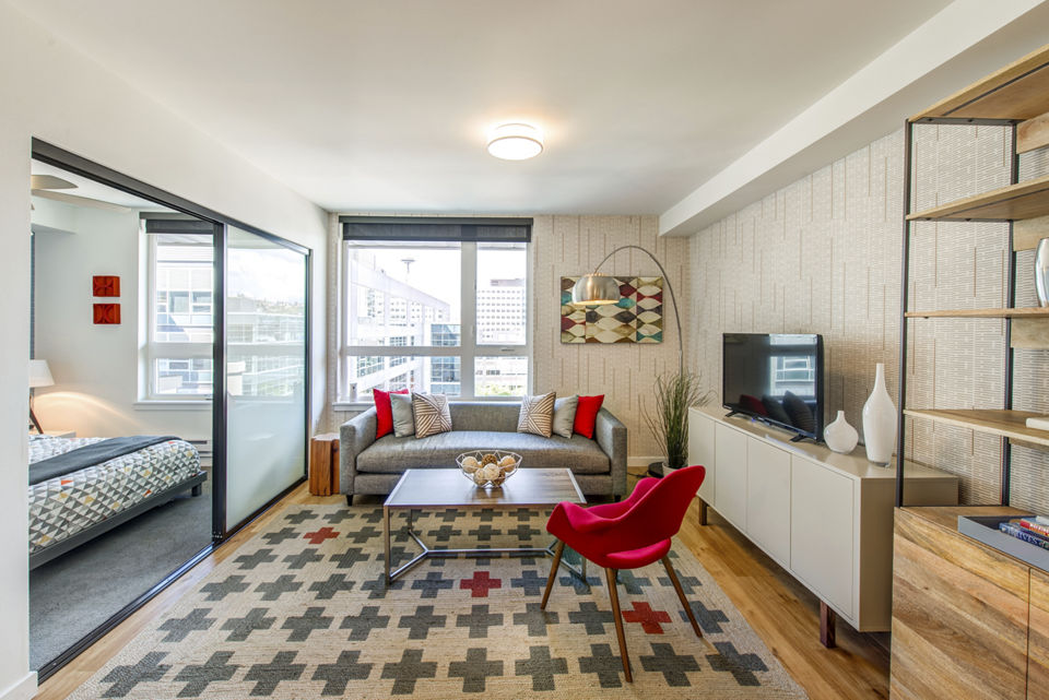 Rooftop area with artificial grass surrounded by modern buildings at Radius Apartments, a luxury community by