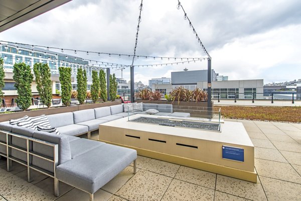 Spacious gym with modern exercise equipment and floor-to-ceiling windows at Radius Apartments