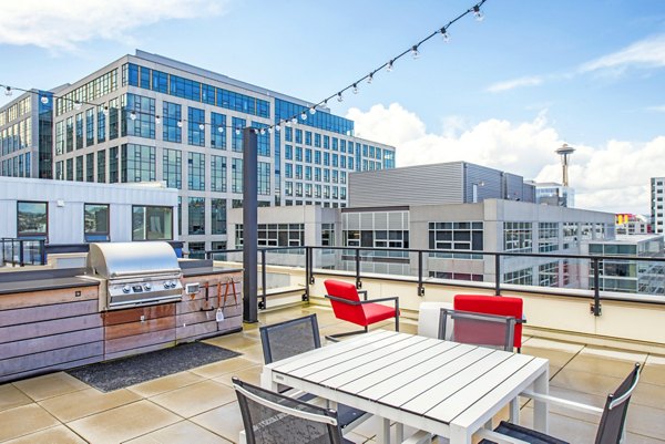 Sleek kitchen with stainless steel appliances and wooden flooring in Radius Apartments, offering modern living spaces in a prime urban location