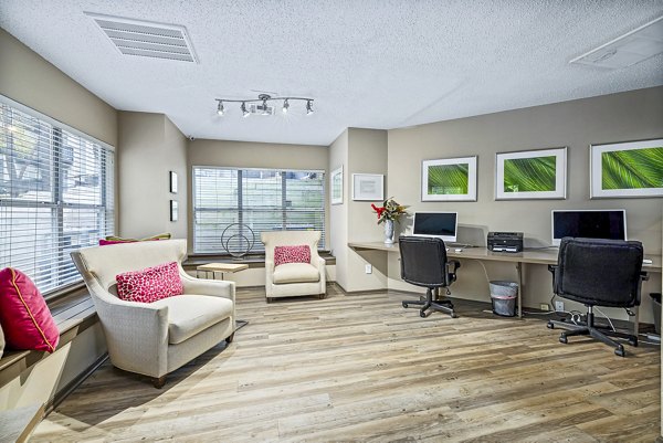 Clubhouse business center with modern seating and workstations at Hamilton Ridge Apartments Perfect space for residents' work and meetings