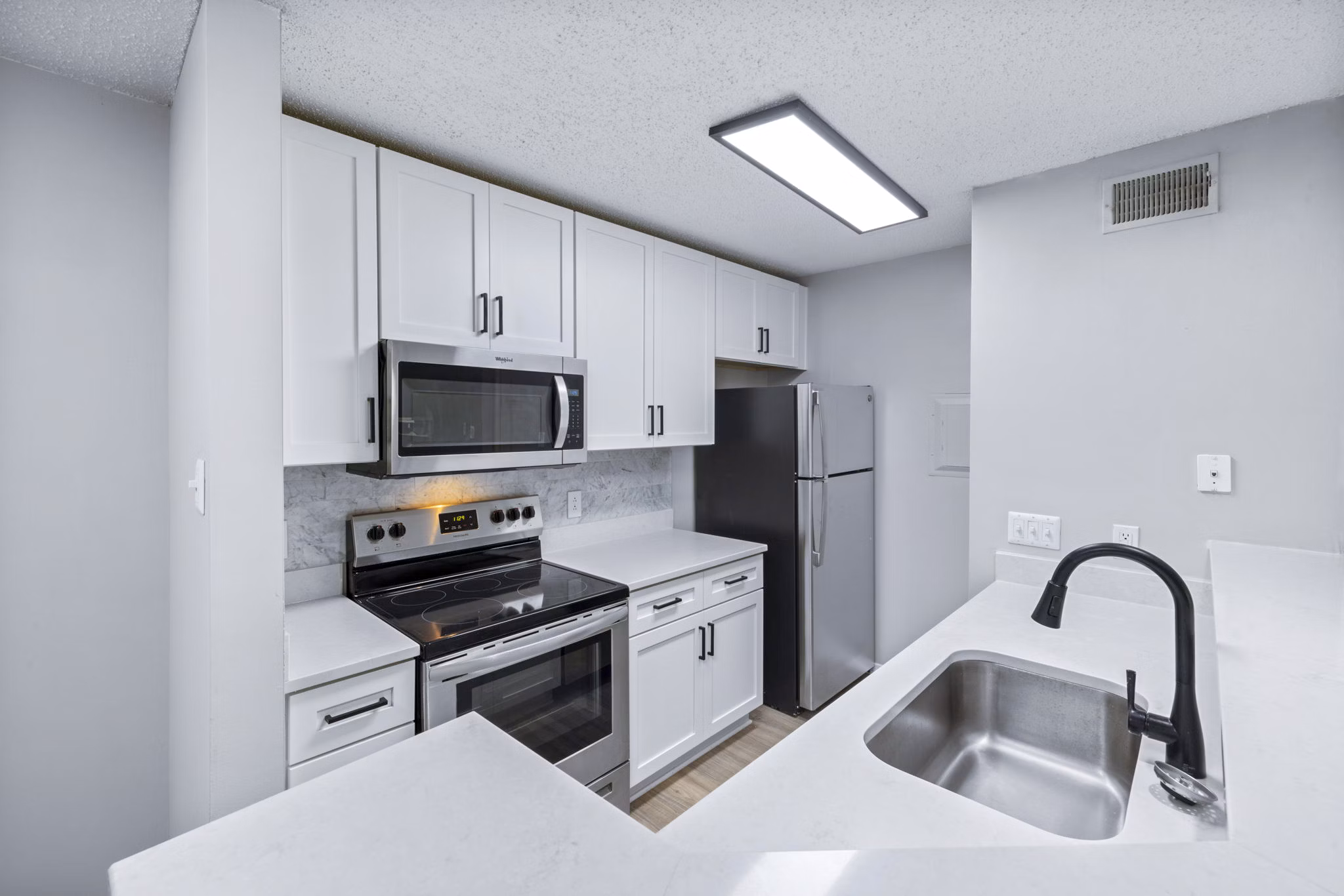 Modern kitchen with stainless steel appliances at Hamilton Ridge Apartments