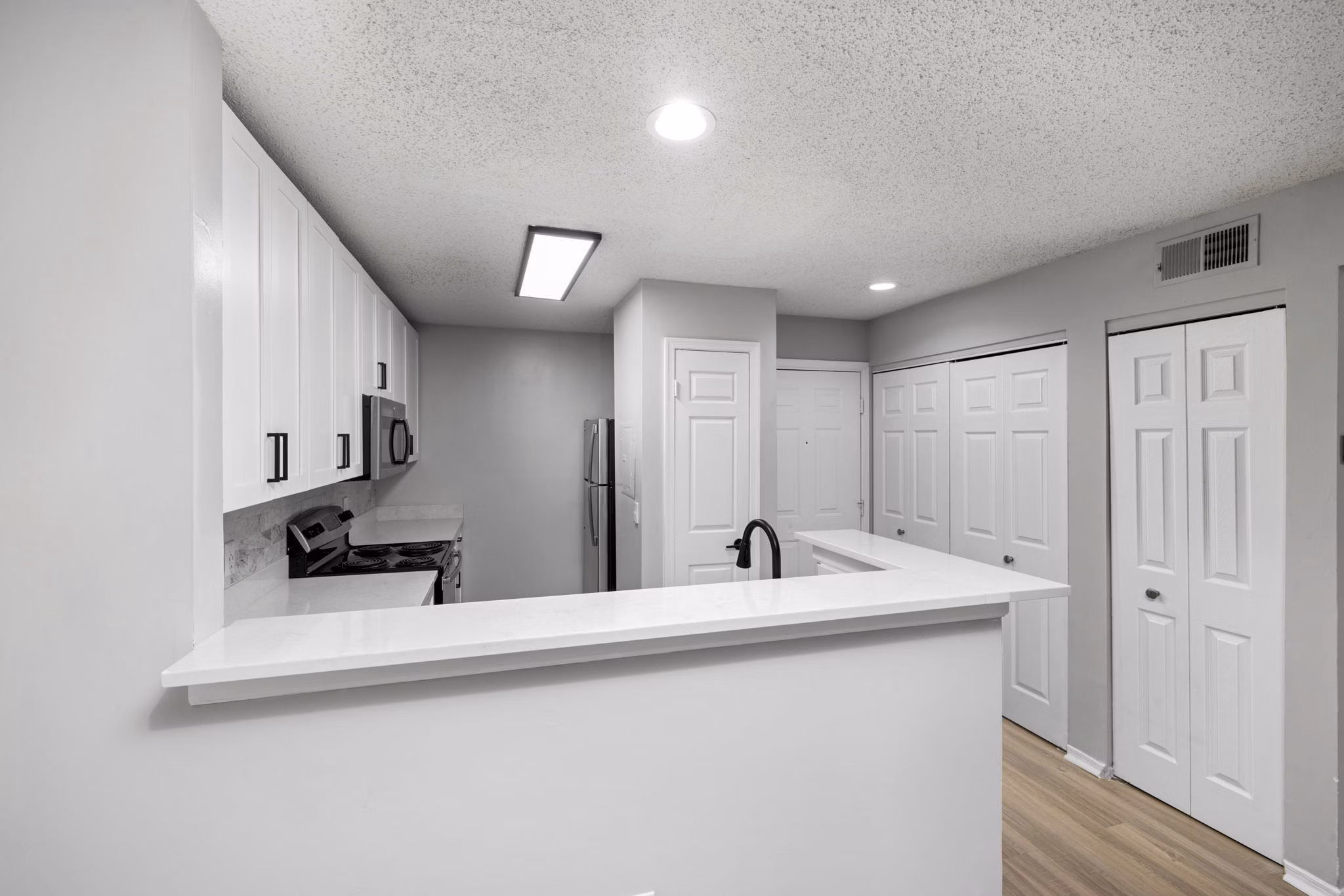 Modern kitchen featuring stainless steel appliances and sleek cabinetry at Hamilton Ridge Apartments