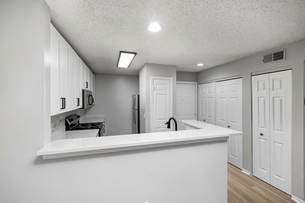 Modern kitchen featuring stainless steel appliances and sleek cabinetry at Hamilton Ridge Apartments