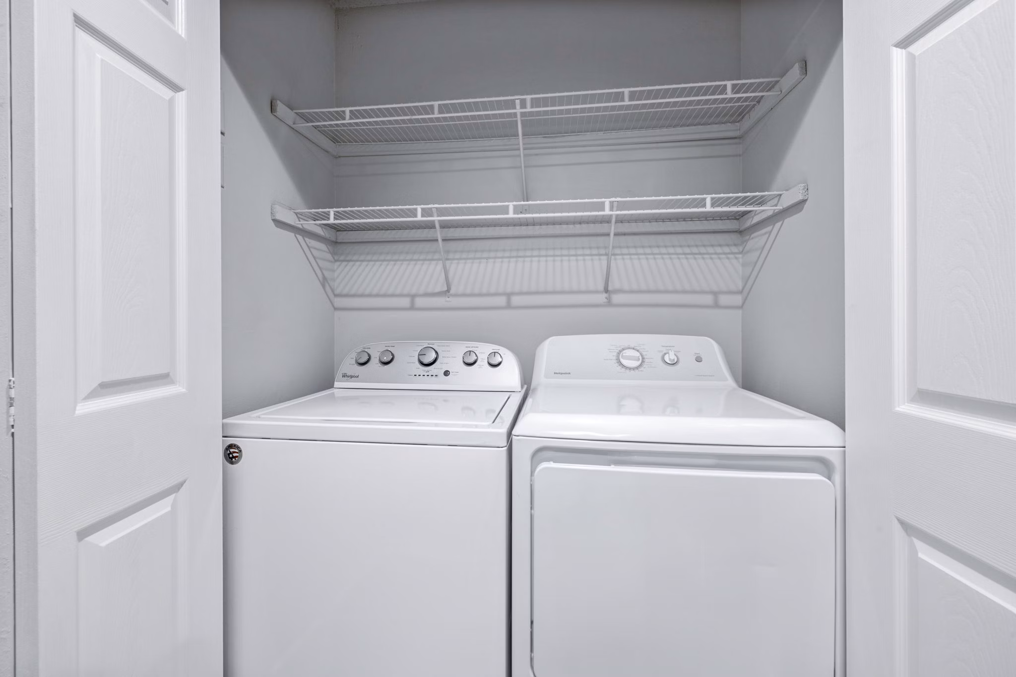 Laundry room with modern appliances and ample storage in Hamilton Ridge Apartments