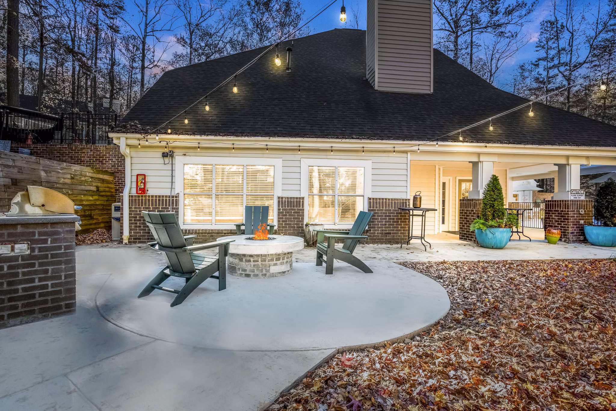 Patio with cozy fire pit at Harvest Apartments, offering luxury outdoor relaxation spaces