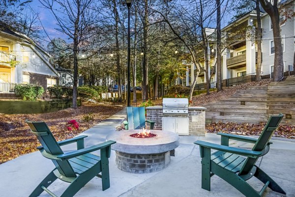 Inviting outdoor patio with fire pit at Harvest Apartments, perfect for gathering and relaxation in a modern apartment community setting