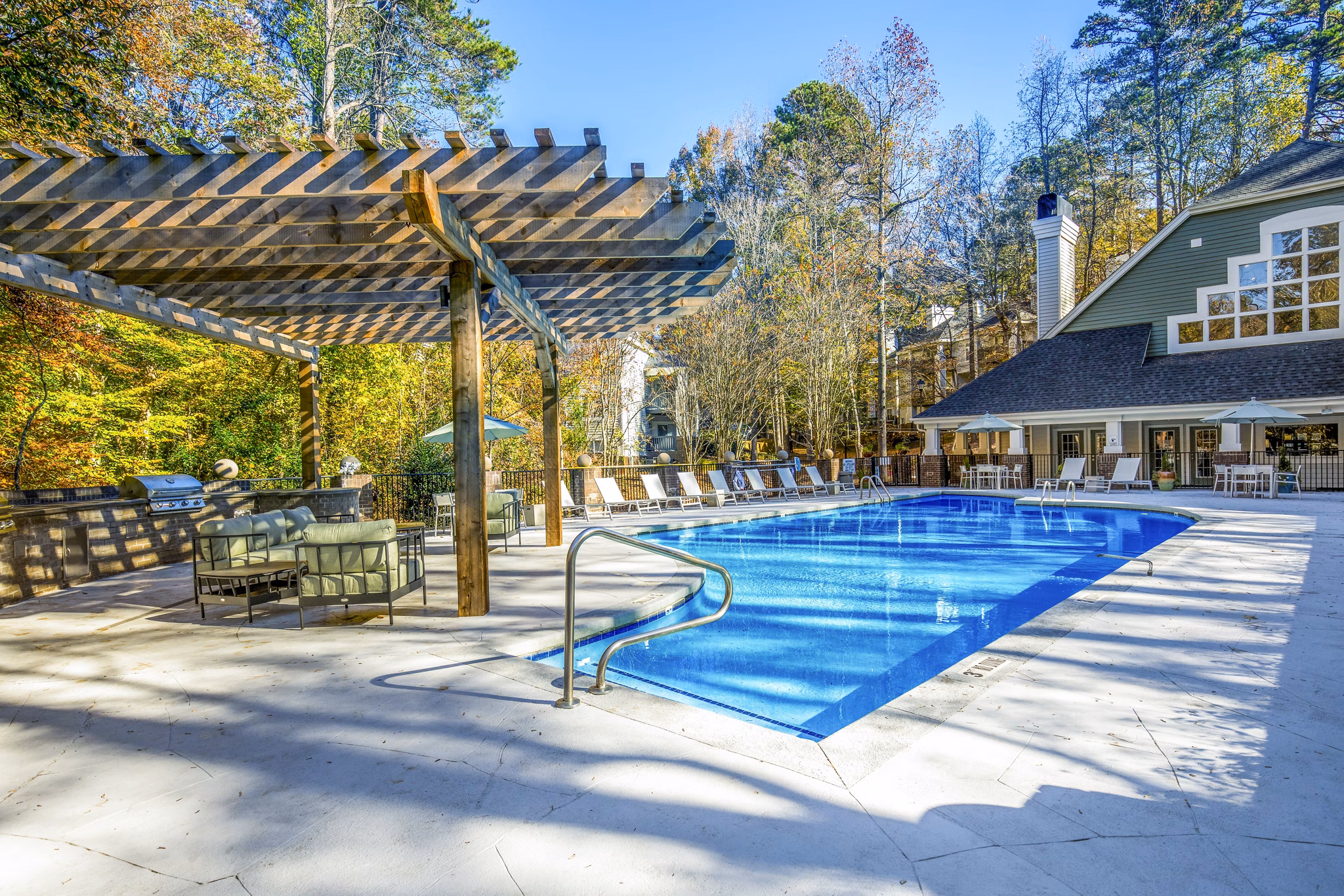 Rooftop pool with lounge chairs at Hamilton Ridge Apartments offering luxury relaxation