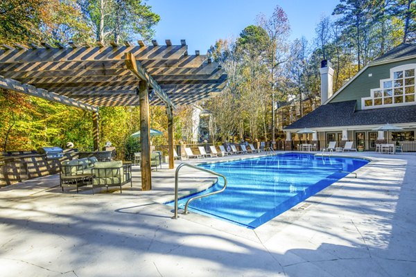 Rooftop pool with lounge chairs at Hamilton Ridge Apartments offering luxury relaxation