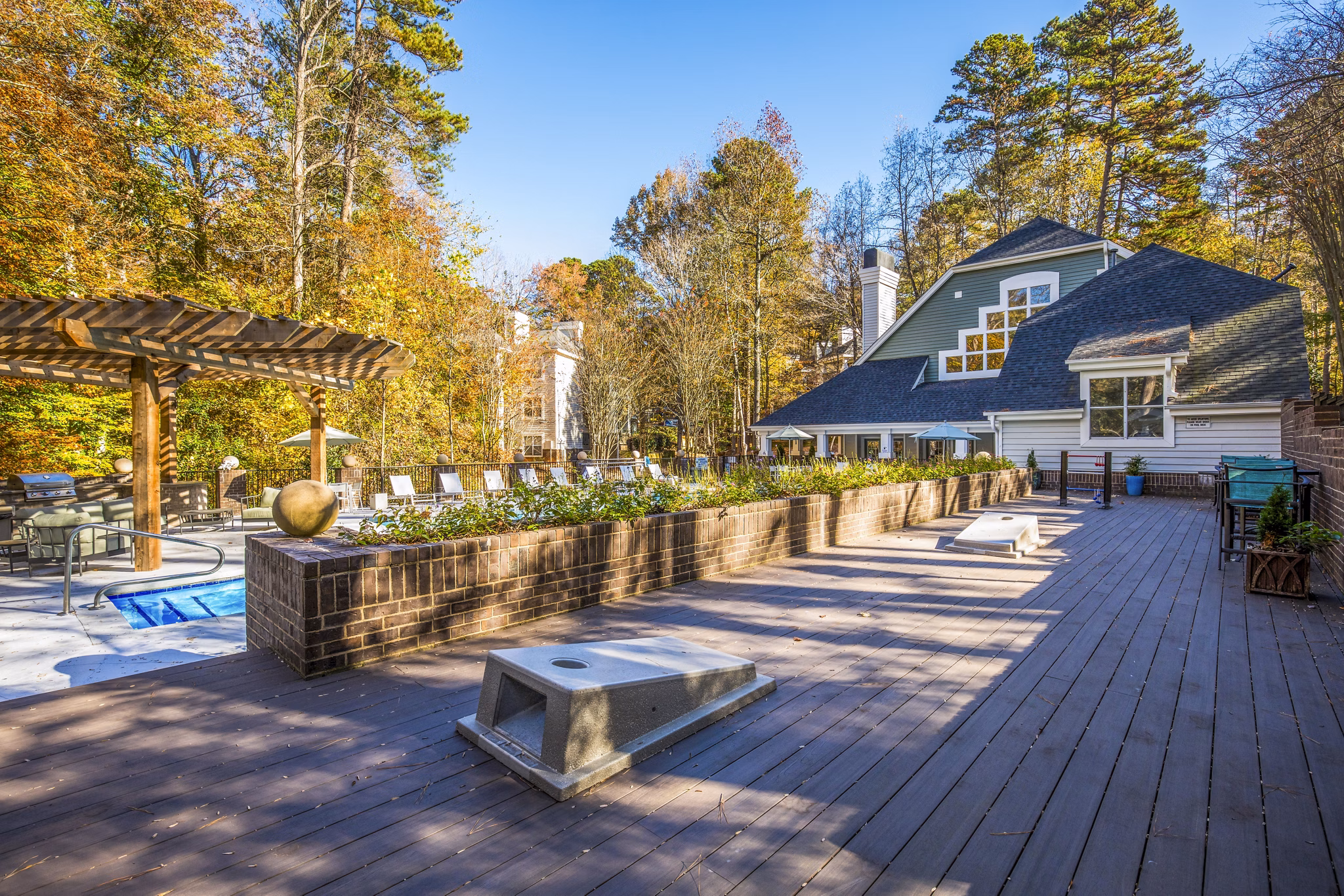 Spacious recreational area with modern seating and greenery at Harvest Apartments, offering luxury living experiences in a vibrant community