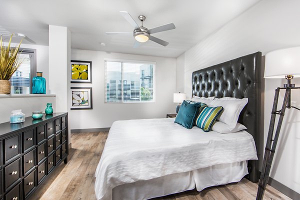 Modern bedroom with minimalist design and ample natural light at Access Culver City Apartments Perfect for comfort and style in a luxury setting