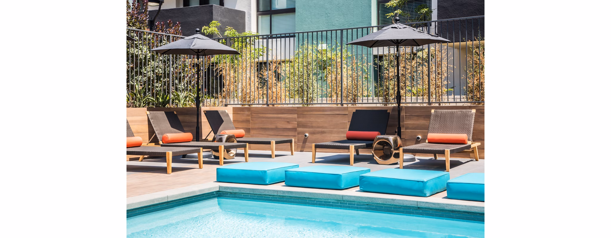 Rooftop pool with lounge chairs and city views at Access Culver City Apartments