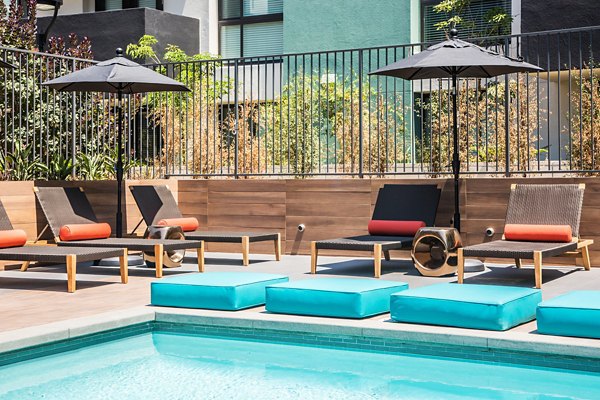 Rooftop pool with lounge chairs and city views at Access Culver City Apartments