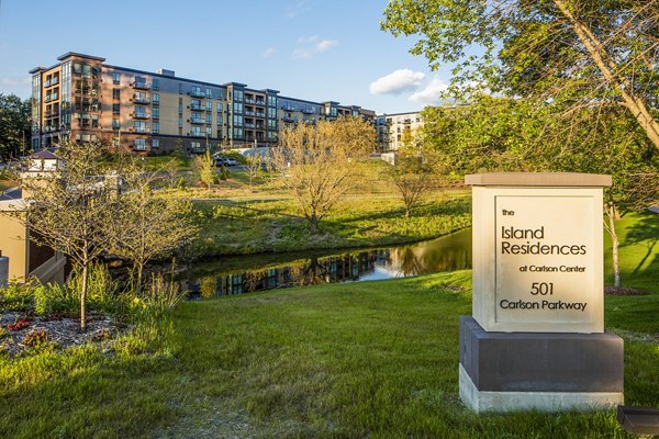 building/exterior at The Island Residences at Carlson Center Apartments