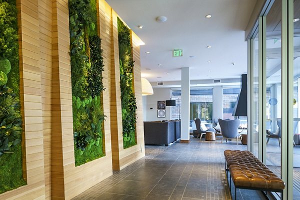 Modern clubhouse lobby with cozy seating at The Island Residences at Carlson Center Apartments