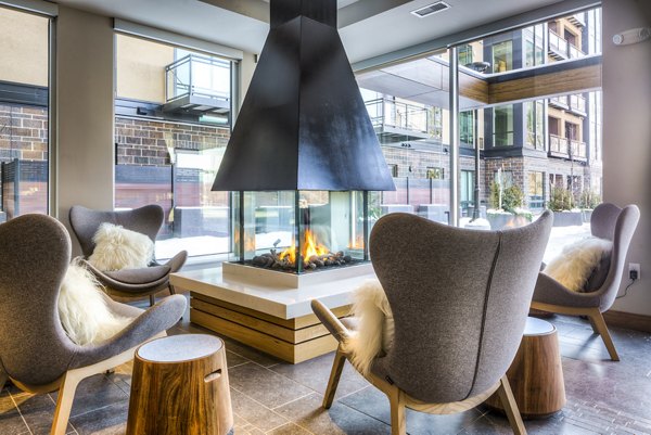 Clubhouse featuring a cozy fireplace at The Island Residences at Carlson Center Apartments for a luxurious ambiance