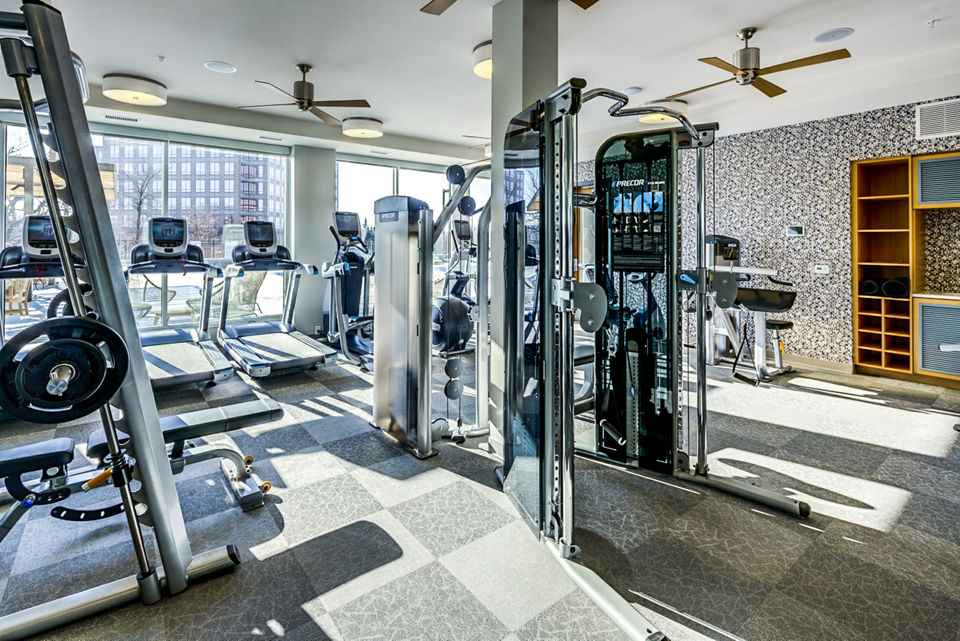 State-of-the-art fitness center with modern equipment at The Island Residences at Carlson Center Apartments