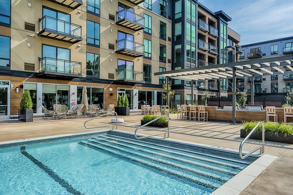 Island Residences: Luxury pool area at Carlson Center apartments offering relaxation and scenic views