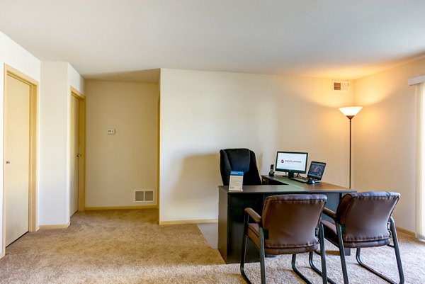 Spacious living room with cozy fireplace and modern decor in Eagles Landing Apartments
