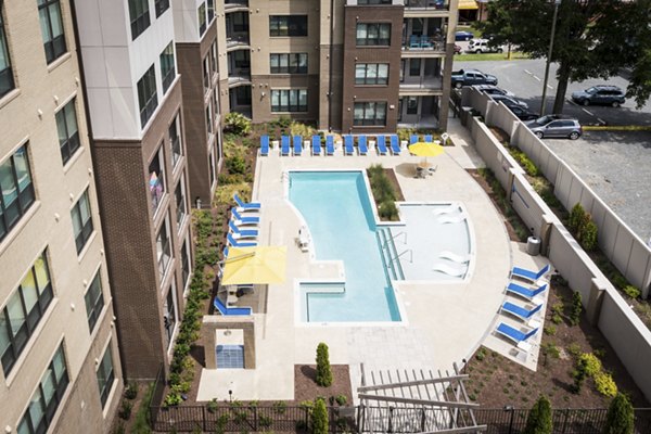 Elegant outdoor pool at 810 NINTH Apartments featuring modern design and lush surroundings, perfect for relaxation and leisure activities