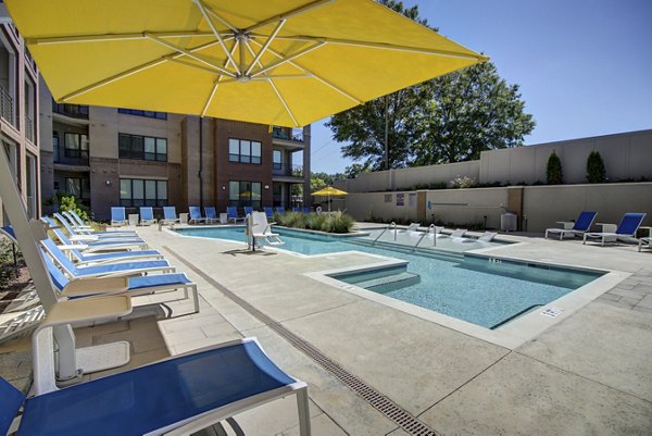 Resort-style pool surrounded by lush landscaping at 810 NINTH Apartments luxury community