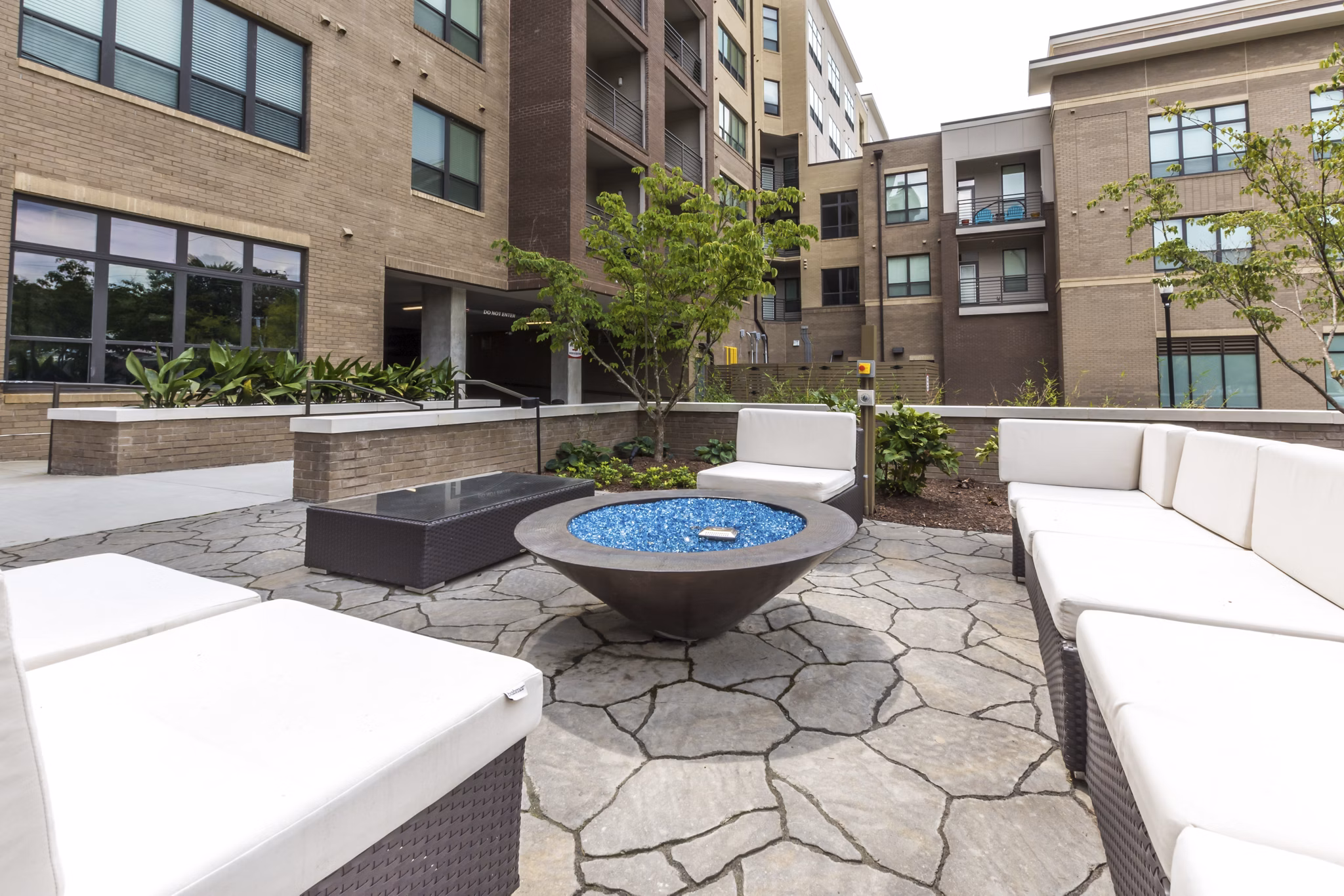 Cozy fire pit area at 810 NINTH Apartments, offering a relaxing outdoor experience in a modern urban setting