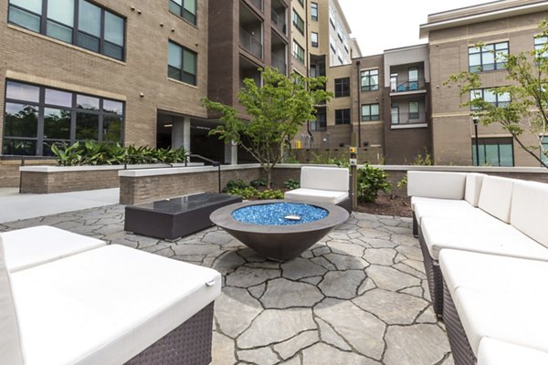 Cozy fire pit area at 810 NINTH Apartments, offering a relaxing outdoor experience in a modern urban setting