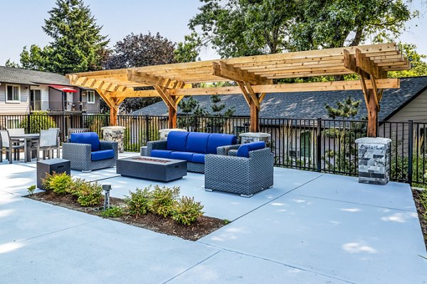 The Alden Apartments: Cozy outdoor patio space with elegant seating and landscaping