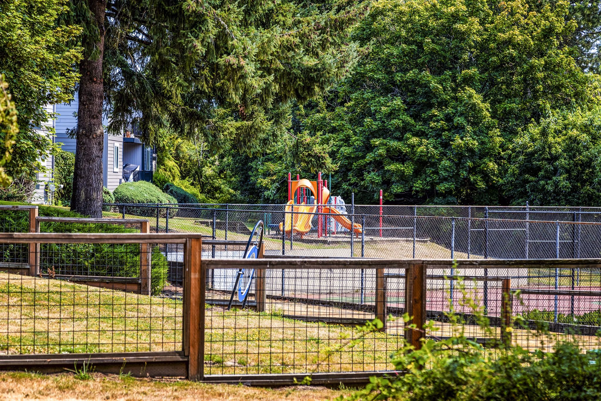 Modern playground with colorful equipment at The Alden Apartments, offering a vibrant outdoor space for families in a luxury setting