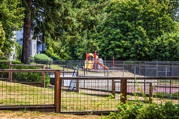 Modern playground with colorful equipment at The Alden Apartments, offering a vibrant outdoor space for families in a luxury setting
