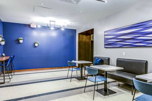 Lobby with modern decor and seating in 2116 Chestnut Apartments clubhouse