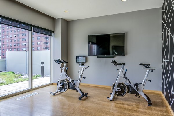Well-equipped yoga/spin studio at 2116 Chestnut Apartments with state-of-the-art bikes and ample space for fitness enthusiasts