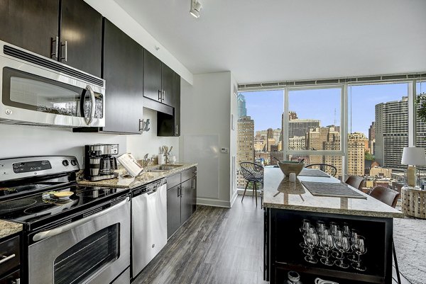 Modern kitchen with stainless steel appliances in 2116 Chestnut Apartments