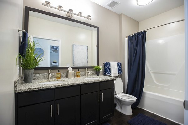 Bathroom featuring sleek fixtures and marble countertops at Residences at Brookline Apartments