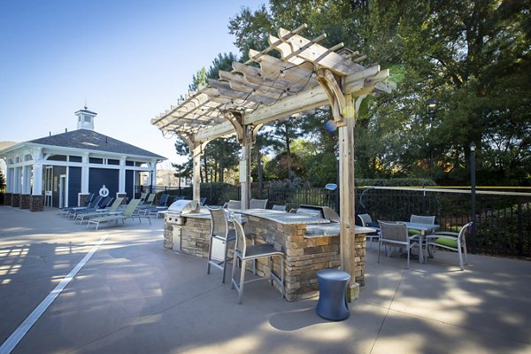 Spacious patio with modern seating and lush greenery at Residences at Brookline Apartments