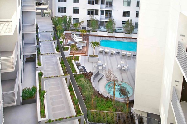 Poolside oasis with sun loungers at The Avenue Hollywood Apartments, luxury living in Los Angeles