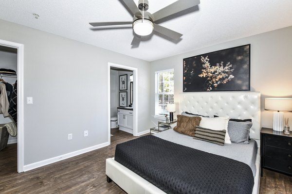 Bedroom featuring cozy decor and a plush bed at Avana Kennesaw Apartments, offering comfort and style in a luxury apartment setting