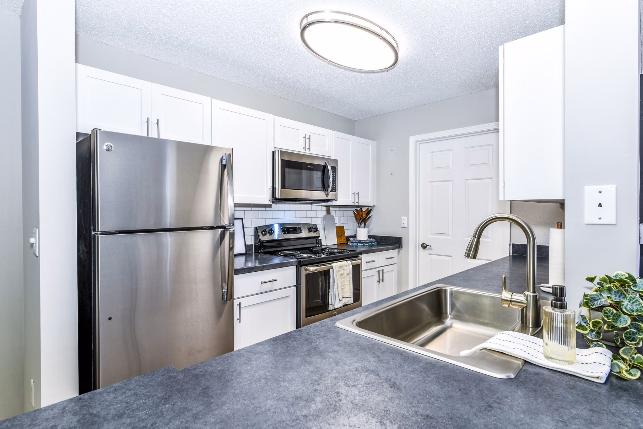 Modern kitchen with stainless steel appliances in Avana Kennesaw Apartments