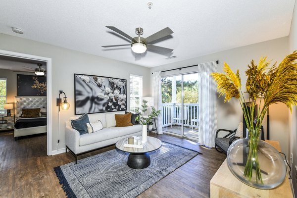 Living room featuring modern decor and natural light at Avana Kennesaw Apartments