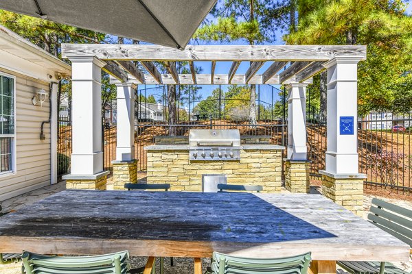 Grill area patio with outdoor seating at Avana Kennesaw Apartments, perfect for social gatherings and leisure activities