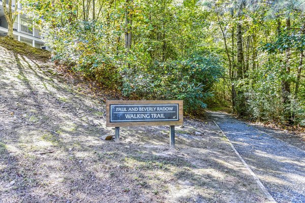 Walking trail surrounded by lush greenery at Avana Kennesaw Apartments
