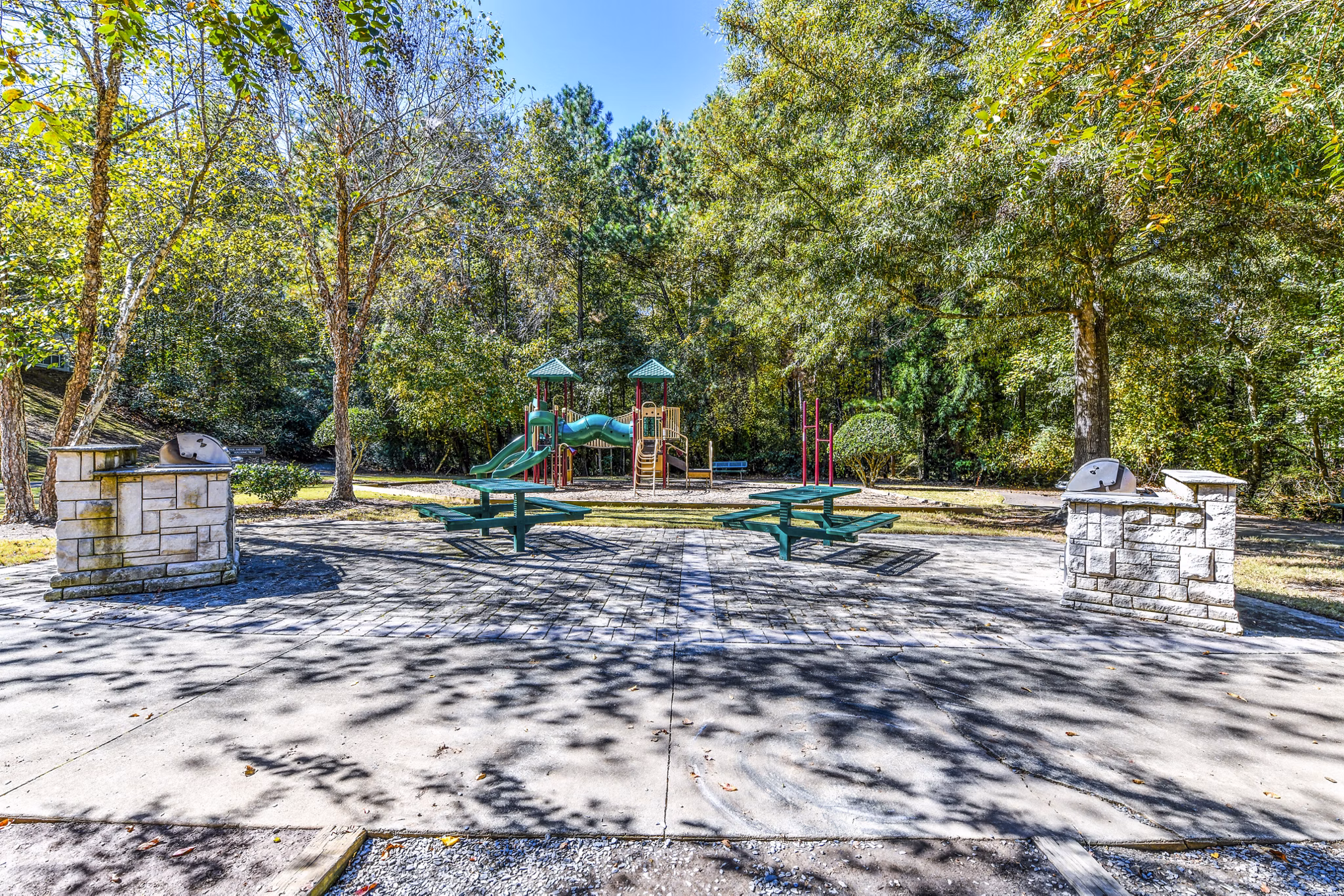 Outdoor grill area and playground at Avana Kennesaw Apartments