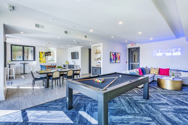 Clubhouse game room featuring billiards and lounge seating at Presley Uptown Apartments