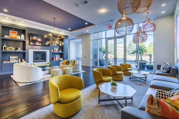 Modern clubhouse with chic decor in Presley Uptown Apartments, featuring stylish lobby seating and ambient lighting for luxury living